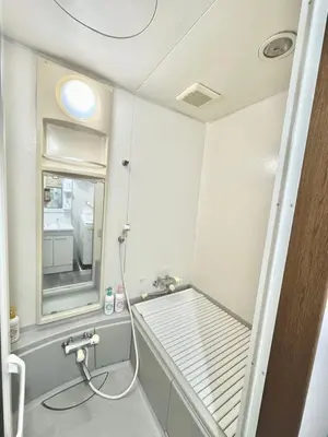a small bathroom with a sink and a mirror at KOBAYASHi \u6771\u4eac in Tokyo