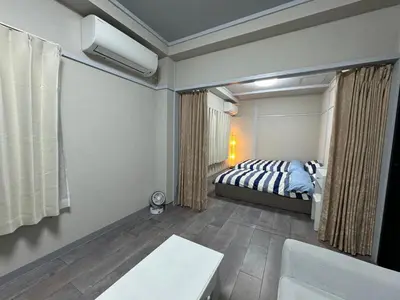 a bedroom with a bed and a tub in it at KOBAYASHi \u6771\u4eac in Tokyo