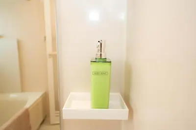 a green bottle is sitting on a shelf in a bathroom at \u677e\u304c\u8c37\u30a2\u30d1\u30fc\u30c8\u30e1\u30f3\u30c8301 in Tokyo
