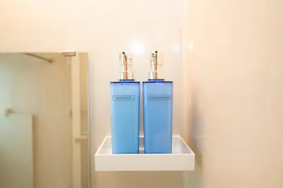 two blue water hydrants on a shelf in a bathroom at \u677e\u304c\u8c37\u30a2\u30d1\u30fc\u30c8\u30e1\u30f3\u30c8301 in Tokyo