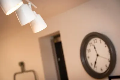 a clock on a wall next to a lamp at \u677e\u304c\u8c37\u30a2\u30d1\u30fc\u30c8\u30e1\u30f3\u30c8101 in Tokyo