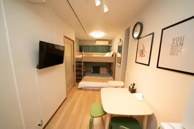 a small room with a desk and a room with a bunk bed at \u677e\u304c\u8c37\u30a2\u30d1\u30fc\u30c8\u30e1\u30f3\u30c8101 in Tokyo