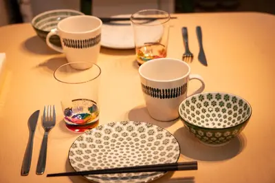 a table with plates and cups and utensils on it at \u677e\u304c\u8c37\u30a2\u30d1\u30fc\u30c8\u30e1\u30f3\u30c8101 in Tokyo