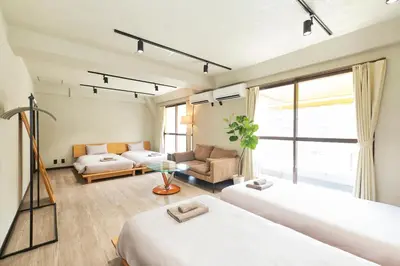 a bedroom with two beds and a living room at ACOE M O R I S H I T A - Direct Access to Tokyo Attractions in Tokyo