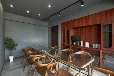 a conference room with a glass table and chairs at ACOE M O R I S H I T A - Direct Access to Tokyo Attractions in Tokyo