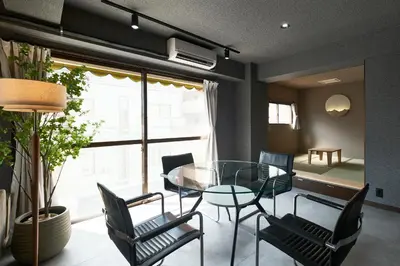 a dining room with a glass table and chairs at ACOE M O R I S H I T A - Direct Access to Tokyo Attractions in Tokyo
