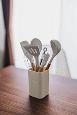 a container filled with utensils on a wooden table at House YOYOGI Park, Shibuya Area, 4 Minutes to Yoyogi Park, 4-Bedroom, Sleeps 8 in Tokyo