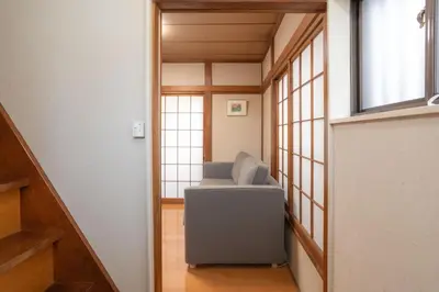 a room with a chair and a window at Kamitagata House in Nakano Sleeps 7Just Steps from Araiyakushi-Mae Station in Tokyo