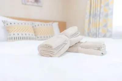 a pile of towels sitting on top of a bed at Kamitagata House in Nakano Sleeps 7Just Steps from Araiyakushi-Mae Station in Tokyo