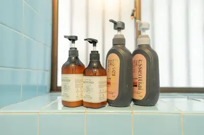 a group of four bottles sitting on top of a counter at Kamitagata House in Nakano Sleeps 7Just Steps from Araiyakushi-Mae Station in Tokyo