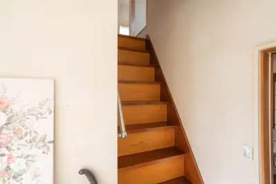 a stairwell in a house with wooden stairs at Kamitagata House in Nakano Sleeps 7Just Steps from Araiyakushi-Mae Station in Tokyo