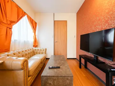a living room with a couch and a flat screen tv at \u6d45\u8349\u99c5\u5f92\u6b694\u5206,\u6d45\u8349\u5bfa8\u5206,\u4e0a\u91ce\u99c55\u5206,\u30ab\u30c3\u30d1\u6a4b\u9053\u5177\u88574\u5206,Switch,Wi-Fi in Tokyo