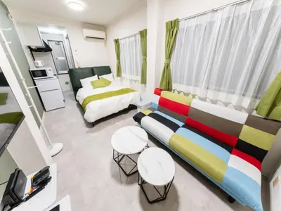 a living room with a couch and a bed at \u6d45\u8349\u99c5\u5f92\u6b694\u5206,\u6d45\u8349\u5bfa8\u5206,\u4e0a\u91ce\u99c55\u5206,\u30ab\u30c3\u30d1\u6a4b\u9053\u5177\u88574\u5206,Switch,Wi-Fi in Tokyo