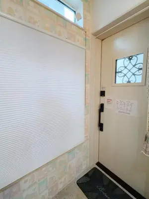 a white garage door in a room with a window at 25平米1Floor studio Max 4P 上北沢sta 3mins Akira&chacha guest home in Tokyo