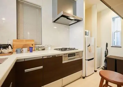 a kitchen with a stove and a refrigerator at Naka HOUSE in Tokyo