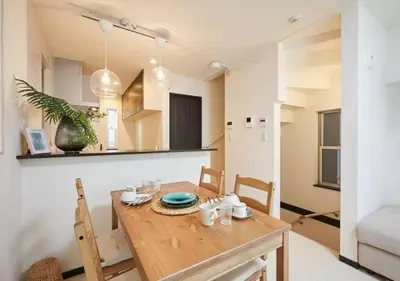 a kitchen and dining room with a wooden table and chairs at Naka HOUSE in Tokyo
