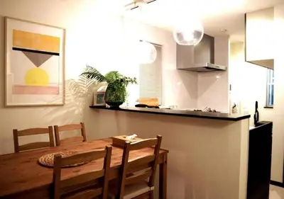a dining room with a wooden table and chairs at Naka HOUSE in Tokyo