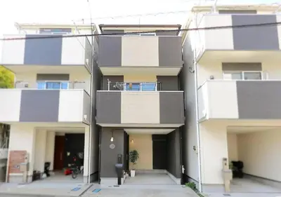 an apartment building with balconies on the side of it at Naka HOUSE in Tokyo