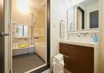 a bathroom with a sink and a shower and a tub at Naka HOUSE in Tokyo