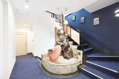 a staircase in a building with a fish tank at Business Hotel Yamashiro in Tokyo