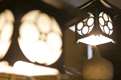 a group of lights on a table with a vase at Business Hotel Yamashiro in Tokyo