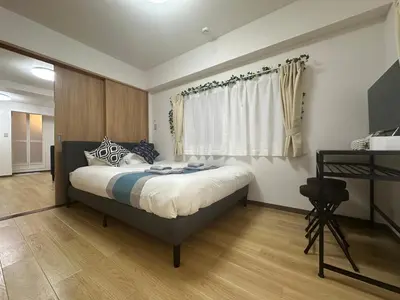 a bedroom with a bed and a window at nestay apartment tokyo kagurazaka in Tokyo