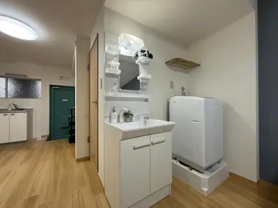 a kitchen with a sink and a refrigerator at nestay apartment tokyo kagurazaka in Tokyo