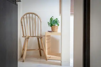 a wooden chair sitting next to a desk with a plant at Sumida River Temple Villa in Tokyo