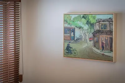 a painting hanging on a wall next to a window at Sumida River Temple Villa in Tokyo