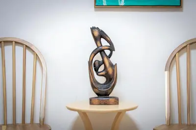 a metal sculpture sitting on a table next to two chairs at Sumida River Temple Villa in Tokyo