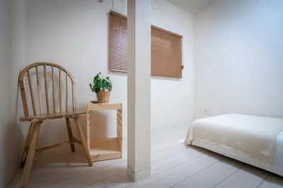 a bedroom with a chair and a bed and a table at Sumida River Temple Villa in Tokyo