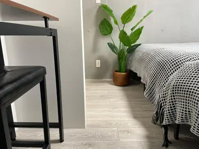 a bedroom with a bed and a potted plant at COMMA HOUSE Otsuka 3-1 in Tokyo