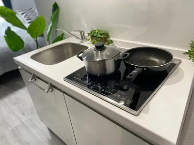 a pot and a pan on a stove in a kitchen at COMMA HOUSE Otsuka 3-1 in Tokyo