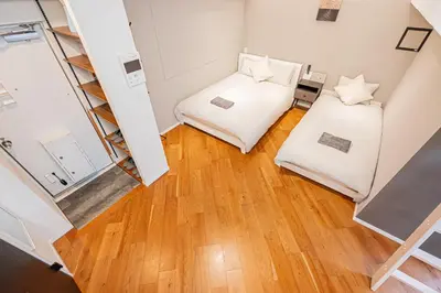 an overhead view of a room with two beds and a ladder at \u65b0\u5bbf\u5340\u6771\u65b0\u5bbf\u7ad9\u5f92\u6b652\u5206\u9418\u623f\u6e90\u4ea4\u901a\u65b9\u4fbf\u514d\u8cbbWi-Fi in Tokyo