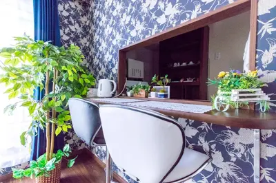 a room with two chairs and a table with plants at Dain Hostel1 in Tokyo