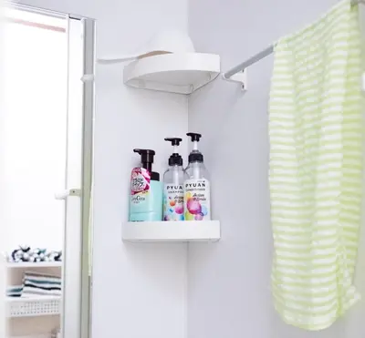 a bathroom with a shelf with toiletries on a wall at Dain Hostel1 in Tokyo