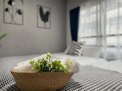 a bowl of flowers sitting on a bed at COMMA HOUSE Otsuka 4-1 in Tokyo