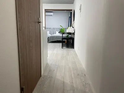 an empty hallway with a room with a table at COMMA HOUSE Otsuka 4-2 in Tokyo