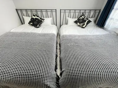 two beds sitting next to each other in a room at COMMA HOUSE Otsuka 4-2 in Tokyo