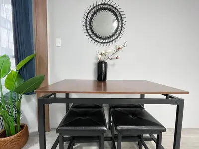 a dining room table with a mirror and two stools at COMMA HOUSE Otsuka 4-2 in Tokyo