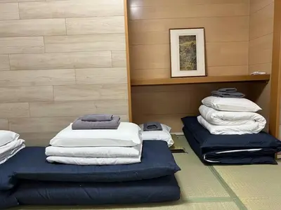 a room with a stack of towels and a pile of pillows at shinjyuku area 602 in Tokyo