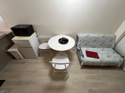 a small living room with a table and a chair at shinjyuku area 602 in Tokyo