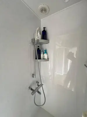 a bathroom with a faucet on a white wall at Shinjyuku area 603 in Tokyo