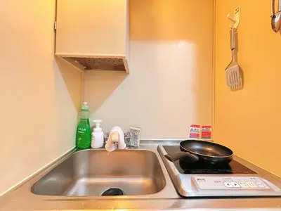 a kitchen sink with a frying pan on top of it at Home Story in Tokyo Kanamachi&東京屋語 in Tokyo