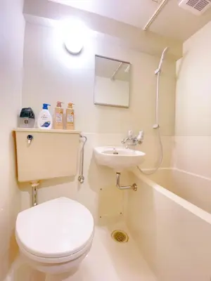 a white bathroom with a toilet and a sink at Home Story in Tokyo Kanamachi&東京屋語 in Tokyo