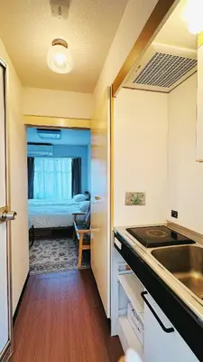 a kitchen with a sink and a bedroom with a bed at Home Story in Tokyo Kanamachi&東京屋語 in Tokyo