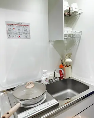 a kitchen with a sink and a frying pan on a stove at Home Story in Tokyo Kanamachi&東京屋語 in Tokyo