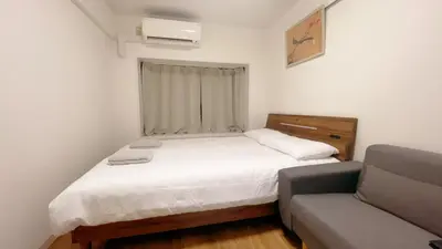 a small bedroom with a bed and a couch at Home Story in Tokyo Kanamachi&東京屋語 in Tokyo