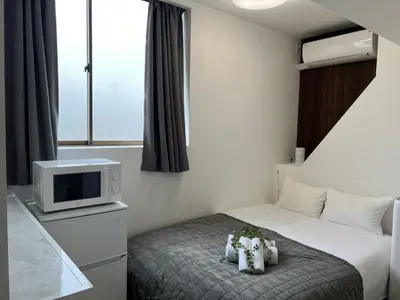 a hotel room with a bed and a tv at Ikebukuro Area R1 NishiikeApartment 5F No Elevator in Tokyo