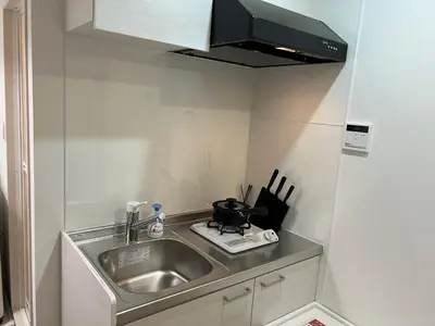 a small kitchen with a sink and a microwave at Ikebukuro Area R1 NishiikeApartment 5F No Elevator in Tokyo